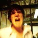 A young man yelling with anger.