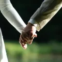 Newly married husband and wife holding hands.