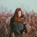 A woman standing in a field of flowers.