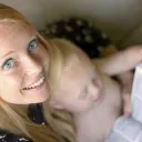 A young mother holding a Bible and reading the Bible.