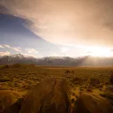 A high plains desert with snow capped mountains in the distance.