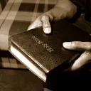 A man holding a Bible.
