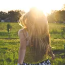 A young woman running in a field.