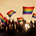 People waving gay pride flags.