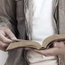 A man reading a Bible.