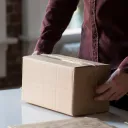 A man packaging a box.