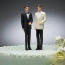 Two men figurines on wedding cake.