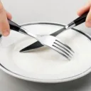 Fork and knife crossing over empty plate - What Does the Bible Teach About Fasti
