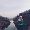 A young woman looking over a lake.