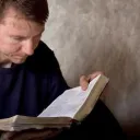 A man reading a Bible.