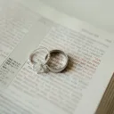 a set of wedding rings on a bible