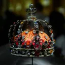 a crown with jewels and red fabric