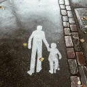 A street with a stencil of a father and child