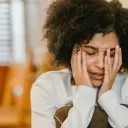 a woman with her head in her hands