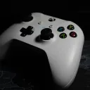 a white video game controller with black buttons