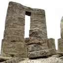 a stack of stones in front of an ancient ruined wall