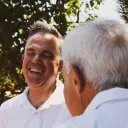 two men talking outside