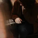 A woman sitting with a Bible on her lap.