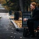 A man sitting on a park bench - thinking.