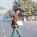 Young man crossing street