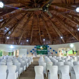 rows of white seats under a wooden roof