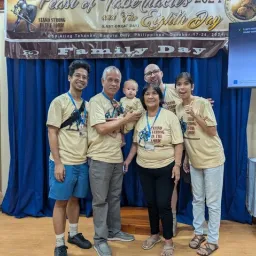 2024 Feast of Tabernacles Baguio City, Philippines five adults and a baby standing under a "Family Day" banner