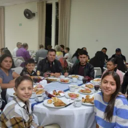 2024 Feast of Tabernacles Panajachel, Guatemala a group of people seated around a table indoors