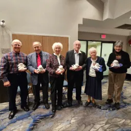 2024 Feast of Tabernacles Kelowna, British Columbia, Canada a group of people standing indoors holding plush sheep