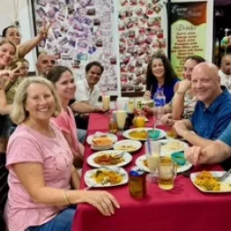 2024 Feast of Tabernacles Penang, Malaysia a group of people sitting and standing around a table with food