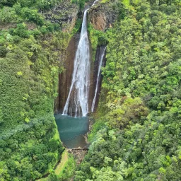 a green landscape with a waterfall