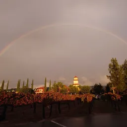 a rainbow in the sky at dusk