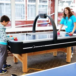 UYC British Isles two children playing at a foosball table