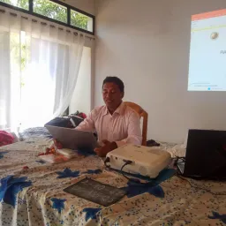a man seated at a table with a laptop