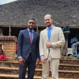 two men standing on a staircase