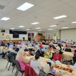 people seated at tables for a meal