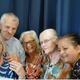 a group of people in front of a blue curtain