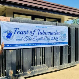 a person standing next to a banner