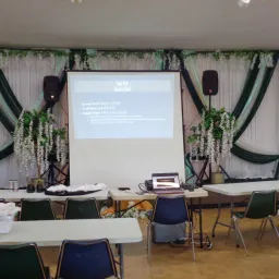 a presenter screen surrounded with decorative drapings