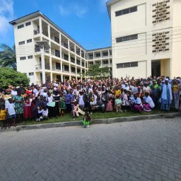 a large group of people outside with buildings in the background