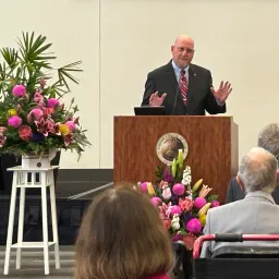 a man standing at a lectern