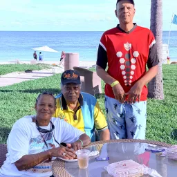 three people at an outdoor table