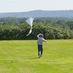 UYC British Isles a child flying a kite in a field