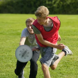 UYC British Isles children running and kicking a soccer ball outdoors