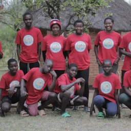 a group of campers standing and sitting outside