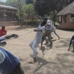 children playing tug of war outside
