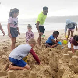 2024 Feast of Tabernacles Mossel Bay, South Africa a group of children building sandcastles