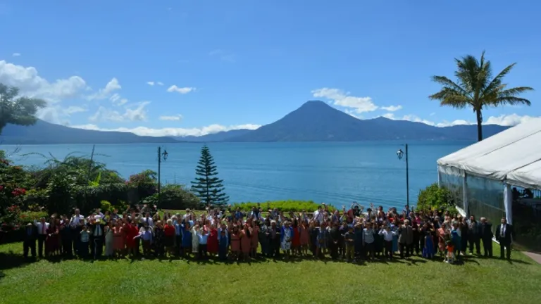 2024 Feast of Tabernacles Panajachel, Guatemala a large group of people outdoors with a body of water and mountain peak in the background