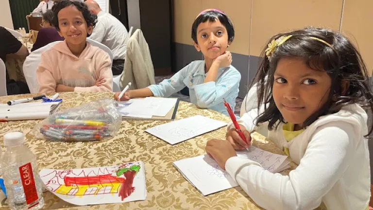 2024 Feast of Tabernacles Agra, India three children seated at a table and drawing on paper