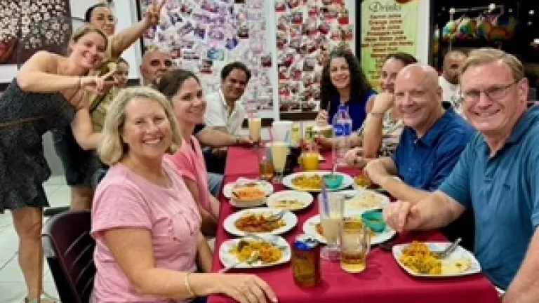 2024 Feast of Tabernacles Penang, Malaysia a group of people sitting and standing around a table with food