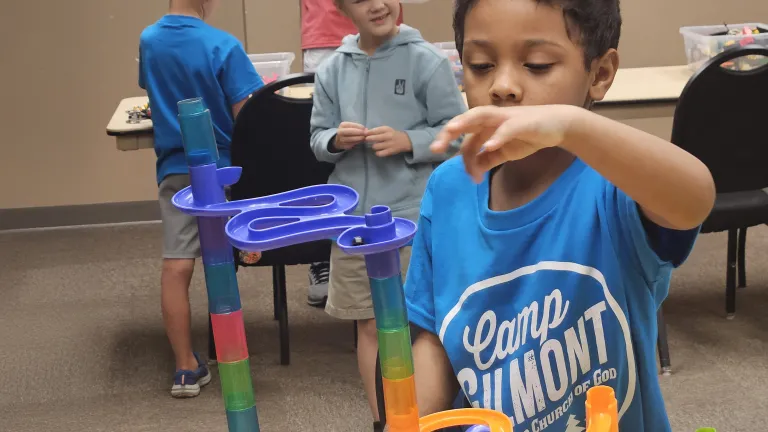 a boy playing with a marble run